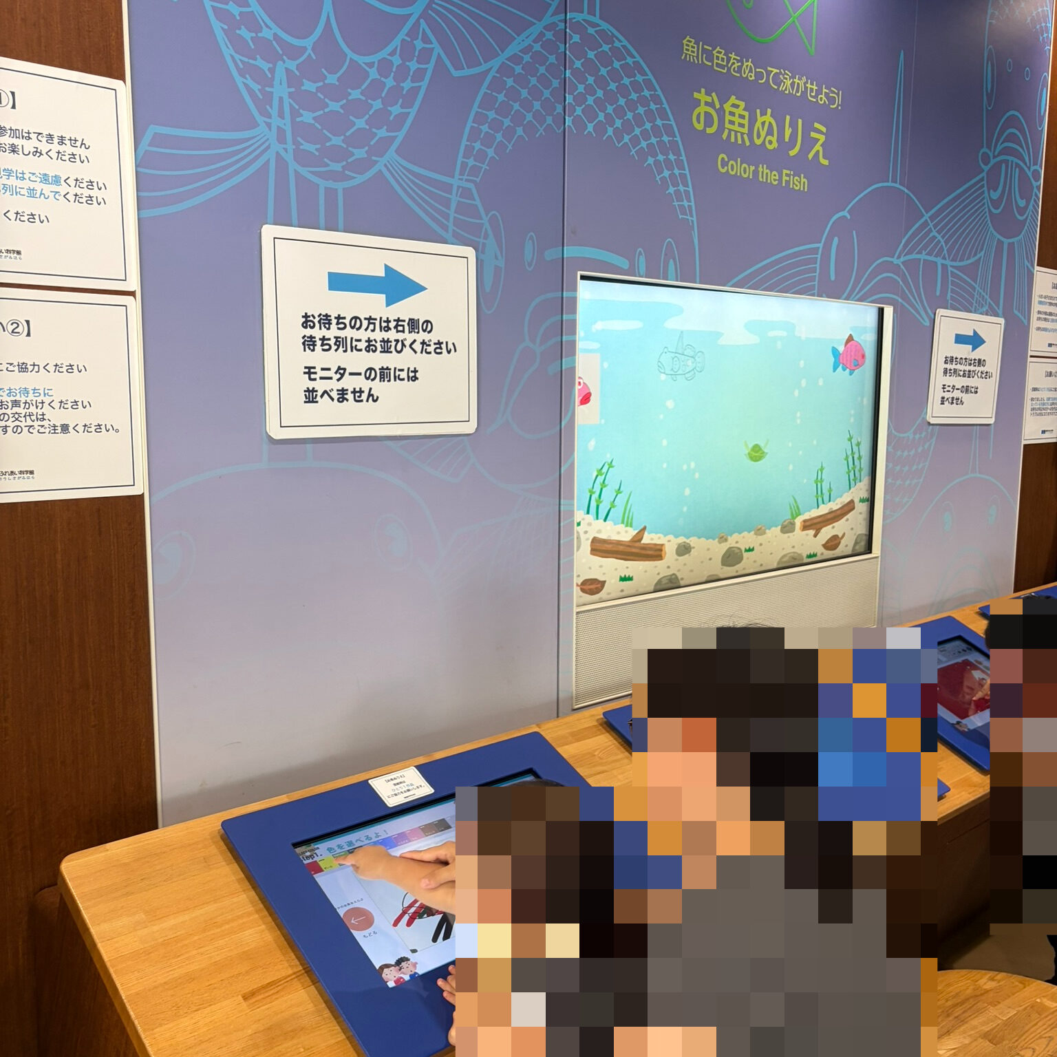 お魚ぬりえコーナーで息子が色塗りをしている写真